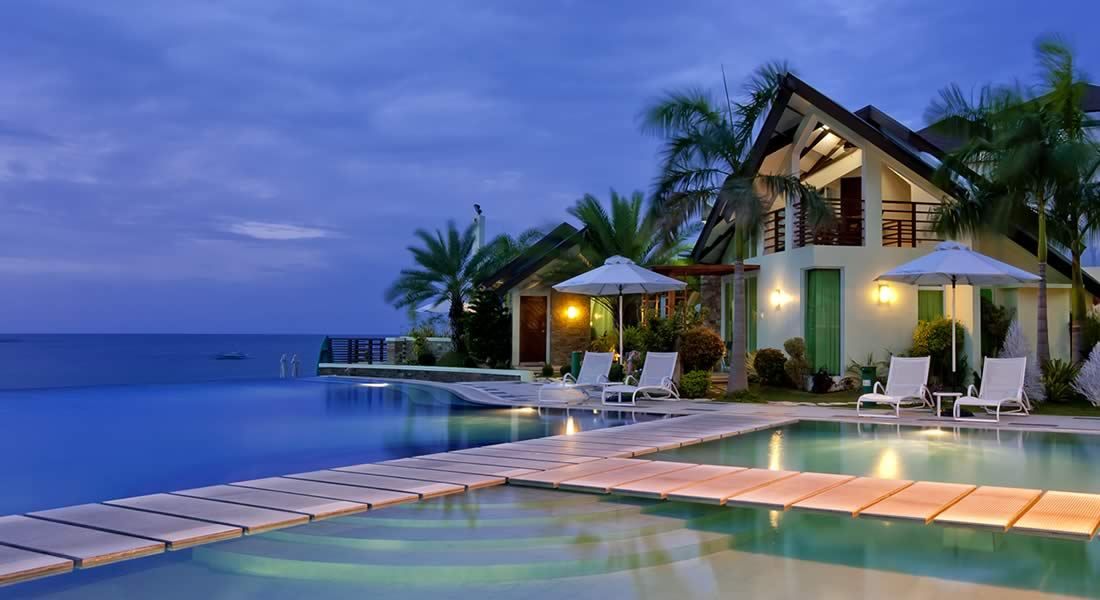 Sea side vacation villa surrounded by water and trees with beautiful view.