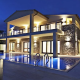 A beautiful villa with swimming pool brightly with lights brightly lip up.